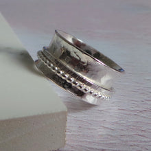 Silver spinner ring with hammered texture